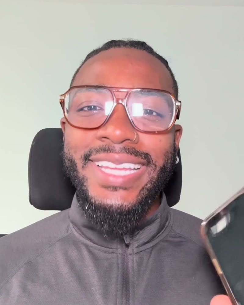 Jameel Scott, smiling, filming the daily video from his desk in Akron, Ohio